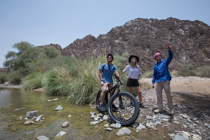 Explore the stunning Hatta landscape as you trek and fat-bike through rocky valleys soaking in the natural beauty and sharing unforgettable moments with friends amidst the serene surroundings.